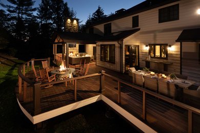 Deck - huge traditional backyard cable railing deck idea in Other with a fireplace