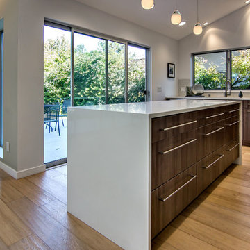 White glass pendent lighting over kitchen island