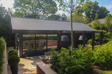 This is an example of a large contemporary detached garden shed and building in Cheshire.