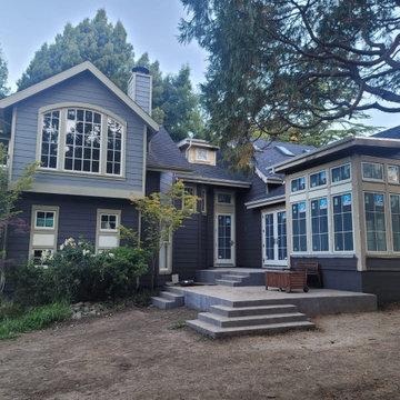 Dark Gray Home Exterior with New Windows and Concrete Patio