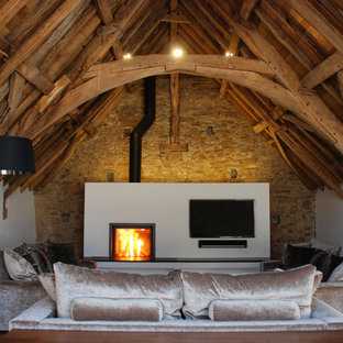 Design ideas for a large rustic living room in Cornwall with white walls, a wood burning stove and a wall mounted tv.