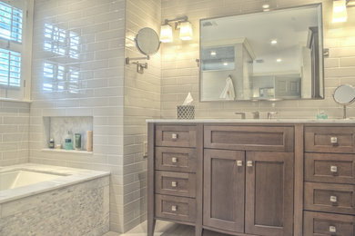 Photo of a large transitional master bathroom in Atlanta with shaker cabinets, light wood cabinets, a corner shower, gray tile, subway tile, grey walls, porcelain floors, an undermount sink, marble benchtops and an undermount tub.