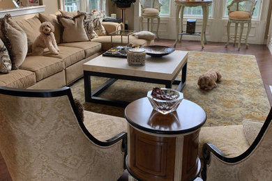 Example of a large enclosed brown floor and dark wood floor living room design in Other with beige walls