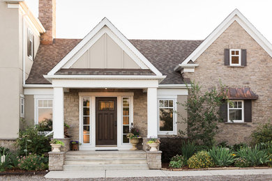 Inspiration for a mid-sized farmhouse gray two-story stone gable roof remodel in Calgary