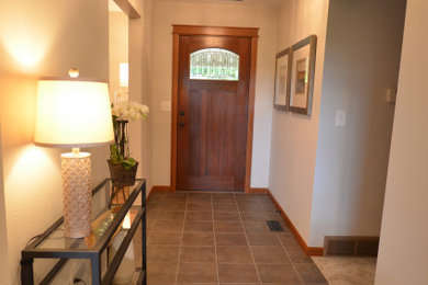 Entryway - small contemporary porcelain tile entryway idea in Portland with gray walls and a medium wood front door