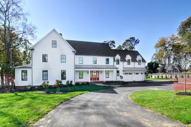 Large beach style white two-story wood exterior home photo in Baltimore with a tile roof