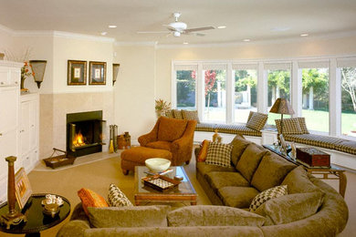Family room - large transitional enclosed carpeted family room idea in Sacramento with beige walls, a standard fireplace, a stone fireplace and no tv