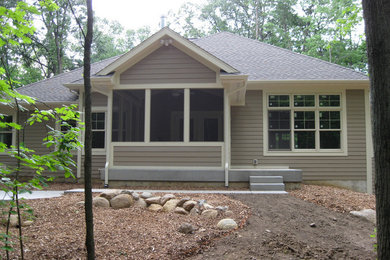 Mid-sized beige one-story concrete fiberboard exterior home photo in Grand Rapids