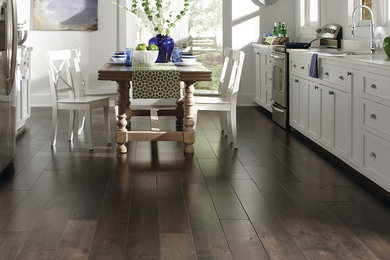 Mid-sized cottage dark wood floor and brown floor kitchen/dining room combo photo in Houston with white walls and no fireplace