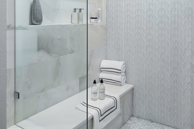 Inspiration for a transitional multicolored tile and stone tile limestone floor freestanding bathtub remodel in Austin with gray walls, a vessel sink and quartz countertops