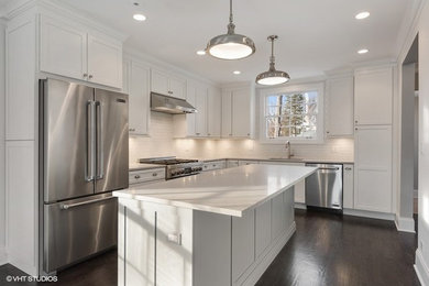 Inspiration for a transitional dark wood floor kitchen remodel in Chicago with an undermount sink, shaker cabinets, white cabinets, quartz countertops, white backsplash, porcelain backsplash and an island