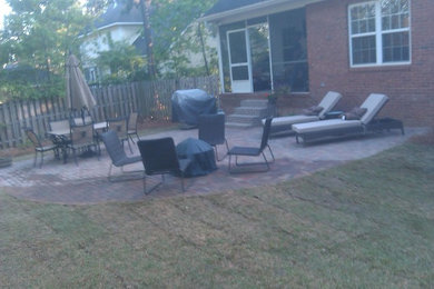 Inspiration for a mid-sized timeless backyard brick patio remodel in Atlanta with no cover