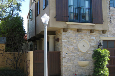 Mid-sized beige two-story stone exterior home idea in San Diego