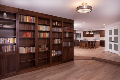 Example of a large transitional u-shaped light wood floor and brown floor eat-in kitchen design in Seattle with a farmhouse sink, dark wood cabinets, white backsplash, subway tile backsplash, stainless steel appliances, an island and white countertops