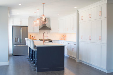 Large transitional l-shaped medium tone wood floor and gray floor open concept kitchen photo in Other with a farmhouse sink, recessed-panel cabinets, white cabinets, quartz countertops, yellow backsplash, mosaic tile backsplash, stainless steel appliances, an island and yellow countertops