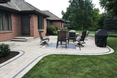 Patio kitchen - large traditional backyard brick patio kitchen idea in Chicago with no cover