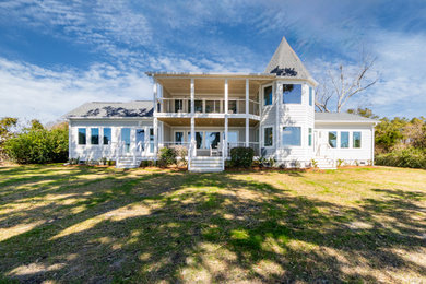 Inspiration for a coastal gray two-story concrete fiberboard and clapboard house exterior remodel in Other with a shingle roof and a gray roof