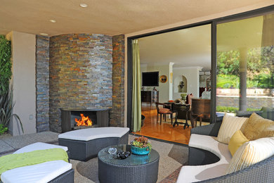 Photo of a mid-sized contemporary backyard patio in Los Angeles with a fire feature, a roof extension and concrete pavers.