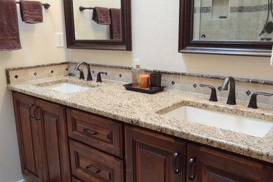 Elegant beige tile and gray tile bathroom photo in Albuquerque with dark wood cabinets and a drop-in sink