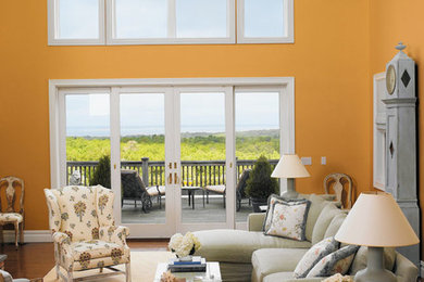 Inspiration for a large transitional formal and open concept medium tone wood floor living room remodel in San Diego with orange walls, no fireplace and no tv
