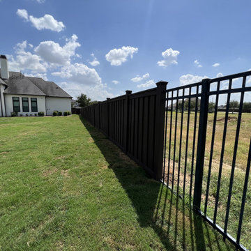 Dark Brown Composite Trex Fence and Black Iron Fence