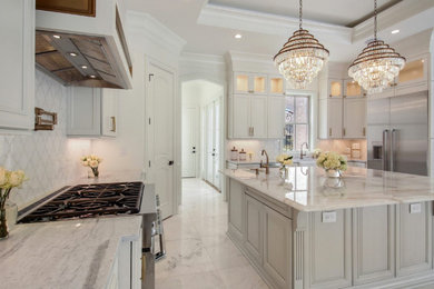 Huge galley marble floor and multicolored floor kitchen pantry photo in Other with a farmhouse sink, raised-panel cabinets, white cabinets, marble countertops, multicolored backsplash, ceramic backsplash, stainless steel appliances, an island and multicolored countertops