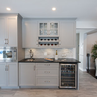 Mid-sized transitional kitchen pantry ideas - Inspiration for a mid-sized transitional u-shaped ceramic floor kitchen pantry remodel in Ottawa with an undermount sink, shaker cabinets, gray cabinets, quartz countertops, gray backsplash, ceramic backsplash, stainless steel appliances and a peninsula