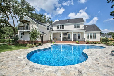 Pool - large traditional backyard concrete paver and custom-shaped natural pool idea in Miami