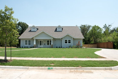 Mid-sized traditional two-storey grey house exterior in Dallas with wood siding, a hip roof and a shingle roof.