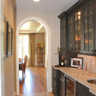 Huge transitional kitchen pantry ideas - Kitchen pantry - huge transitional galley limestone floor kitchen pantry idea in Providence with an undermount sink, granite countertops, beige backsplash, stainless steel appliances, glass-front cabinets and dark wood cabinets