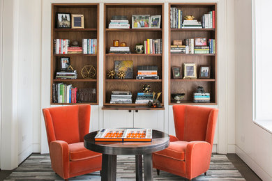 Example of a transitional enclosed family room library design in New York with white walls