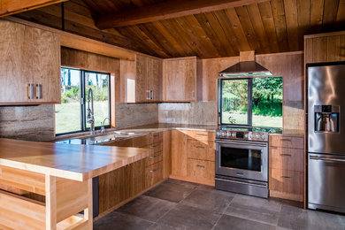 This is an example of a small country l-shaped eat-in kitchen in Seattle with a single-bowl sink, flat-panel cabinets, medium wood cabinets, marble benchtops, multi-coloured splashback, marble splashback, stainless steel appliances, porcelain floors, with island and grey floor.