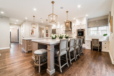 Inspiration for a cottage kitchen remodel in Chicago with two islands and beige countertops