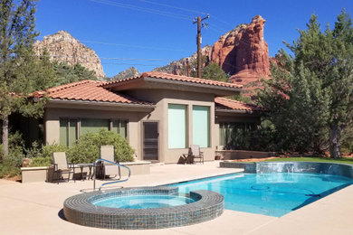 Small trendy green one-story stucco house exterior photo in Phoenix with a hip roof and a tile roof