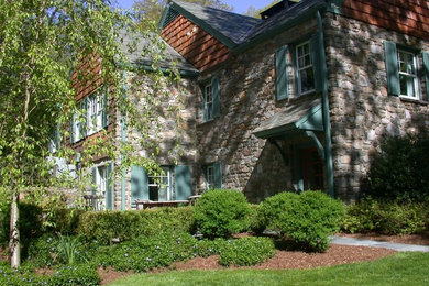 Inspiration for a large timeless gray two-story mixed siding gable roof remodel in New York