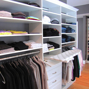 Master bedroom walk-in closet with pull-out ironing board, plenty of drawe