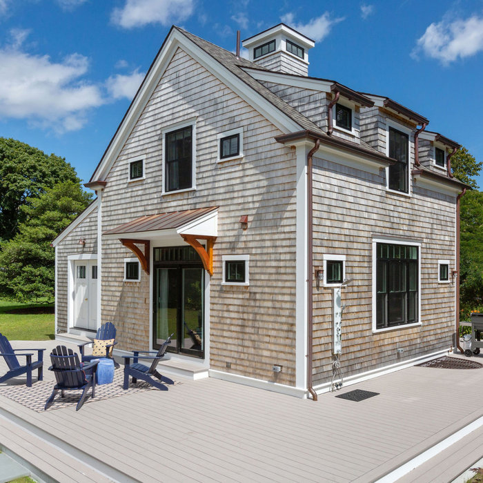 Inspiration for a two-story wood and shingle exterior home remodel in Boston