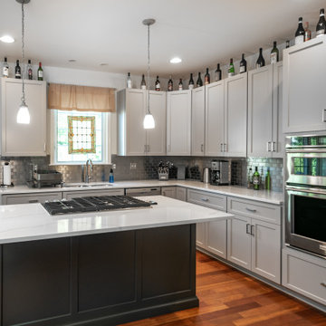 Platinum Gray Kitchen with a Graphite Gray Island and White and Gray Quartz Tops