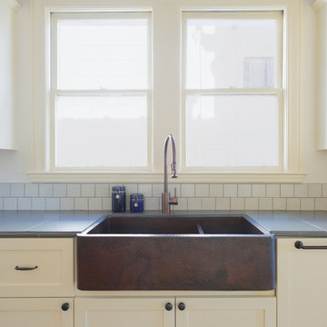 Short backsplash made up of 4x4 tiles in Gardenia.