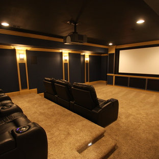 Example of a large classic enclosed carpeted and beige floor home theater design in Raleigh with a projector screen and black walls