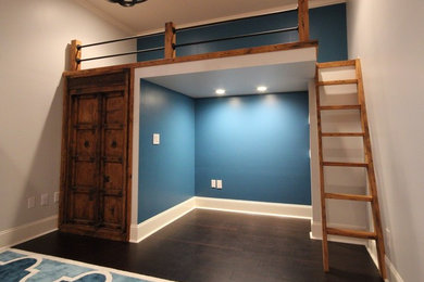Example of a large trendy gender-neutral dark wood floor and brown floor kids' room design in Charlotte with blue walls