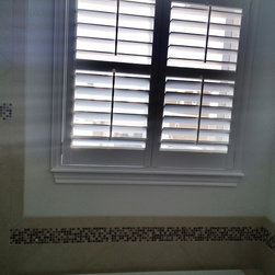Crestview Shutters using large Deco frame and bi-fold track shutters - Interior Shutters
