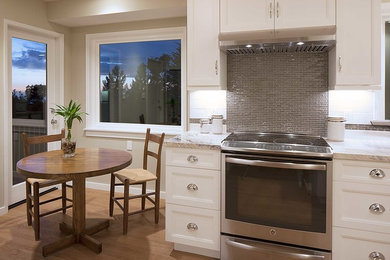 Example of a mid-sized arts and crafts galley vinyl floor and brown floor kitchen design in San Francisco with a double-bowl sink, shaker cabinets, white cabinets, granite countertops, white backsplash, ceramic backsplash and stainless steel appliances