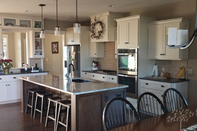 Kitchen - mid-sized transitional l-shaped medium tone wood floor and brown floor kitchen idea in Other with an undermount sink, shaker cabinets, white cabinets, beige backsplash, matchstick tile backsplash, stainless steel appliances and an island
