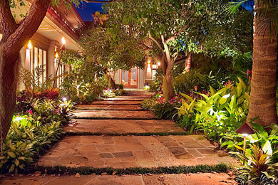 This is an example of a large tropical front yard stone landscaping in Hawaii.