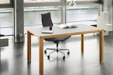 Großes Modernes Arbeitszimmer mit Studio, grauer Wandfarbe, Betonboden, freistehendem Schreibtisch und grauem Boden in Berlin