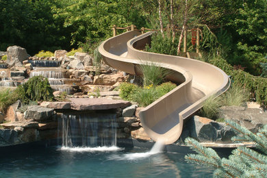 Example of a large backyard custom-shaped natural water slide design in New York