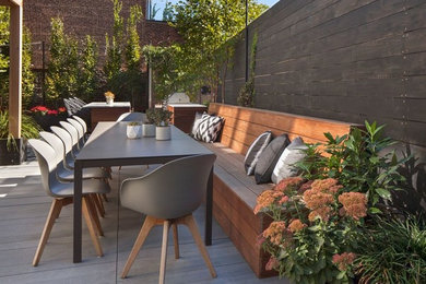 Photo of a large contemporary backyard patio in New York with an outdoor kitchen, decking and a gazebo/cabana.