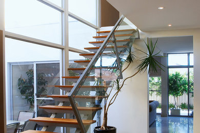 Inspiration for a contemporary wood straight staircase in Perth with open risers.