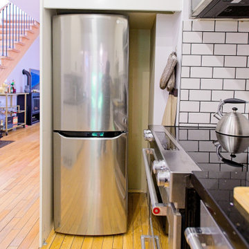 White Galley Kitchen with Stainless Refrigerator and Wood Floor | East York